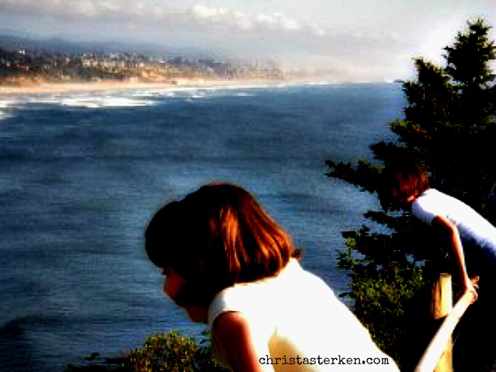 girls overlooking an ocean