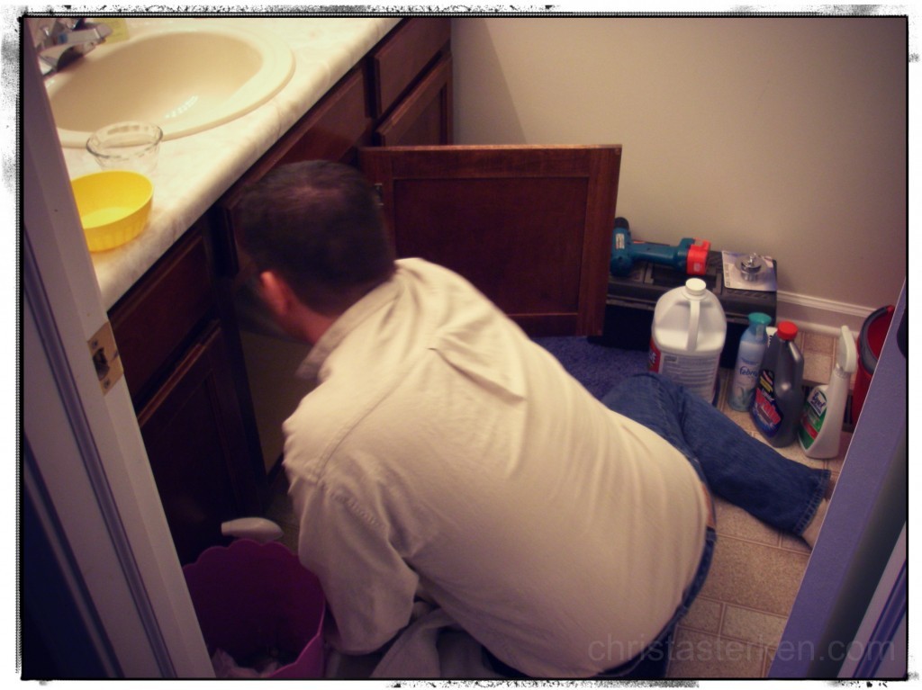 man fixing a bathroom sink