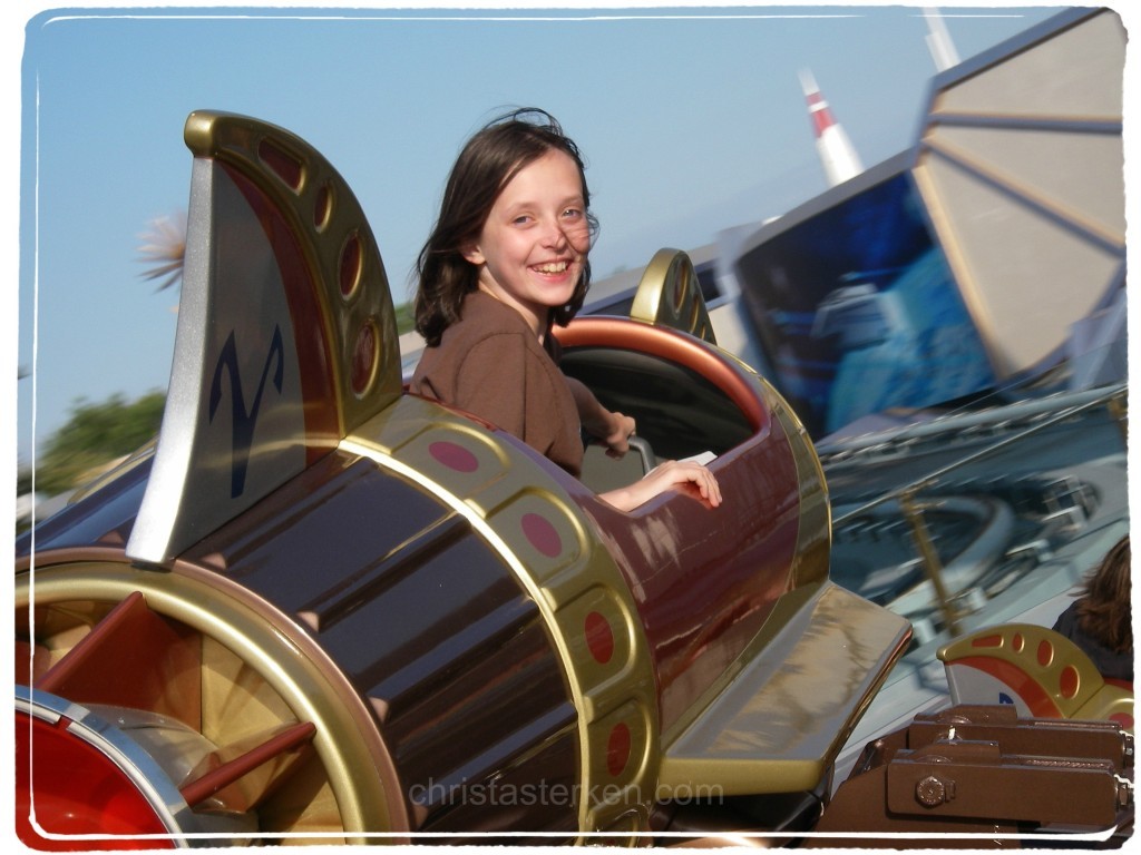 little girl on flying rocket ride