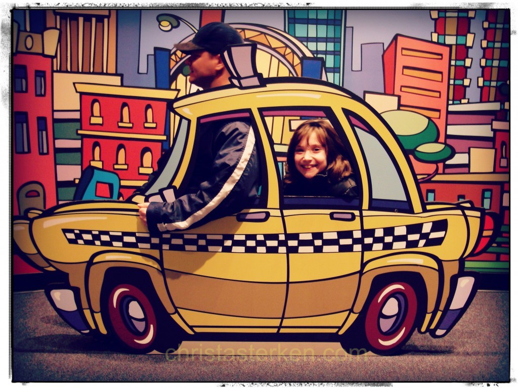 man in prop car with little girl laughing