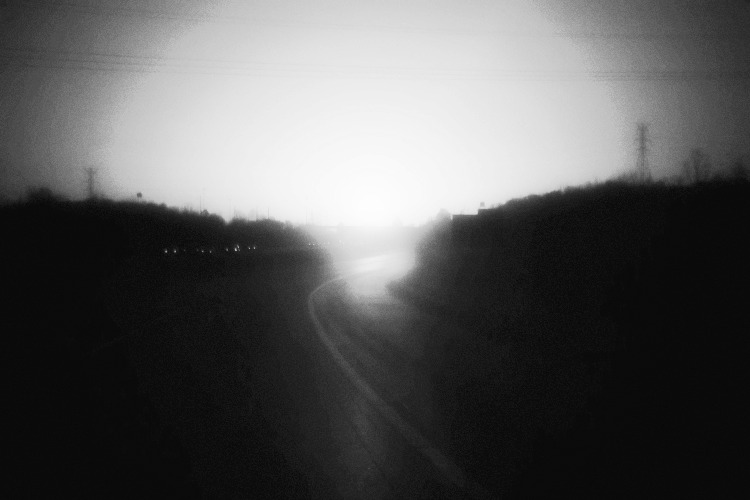 a blurry black and white sunset