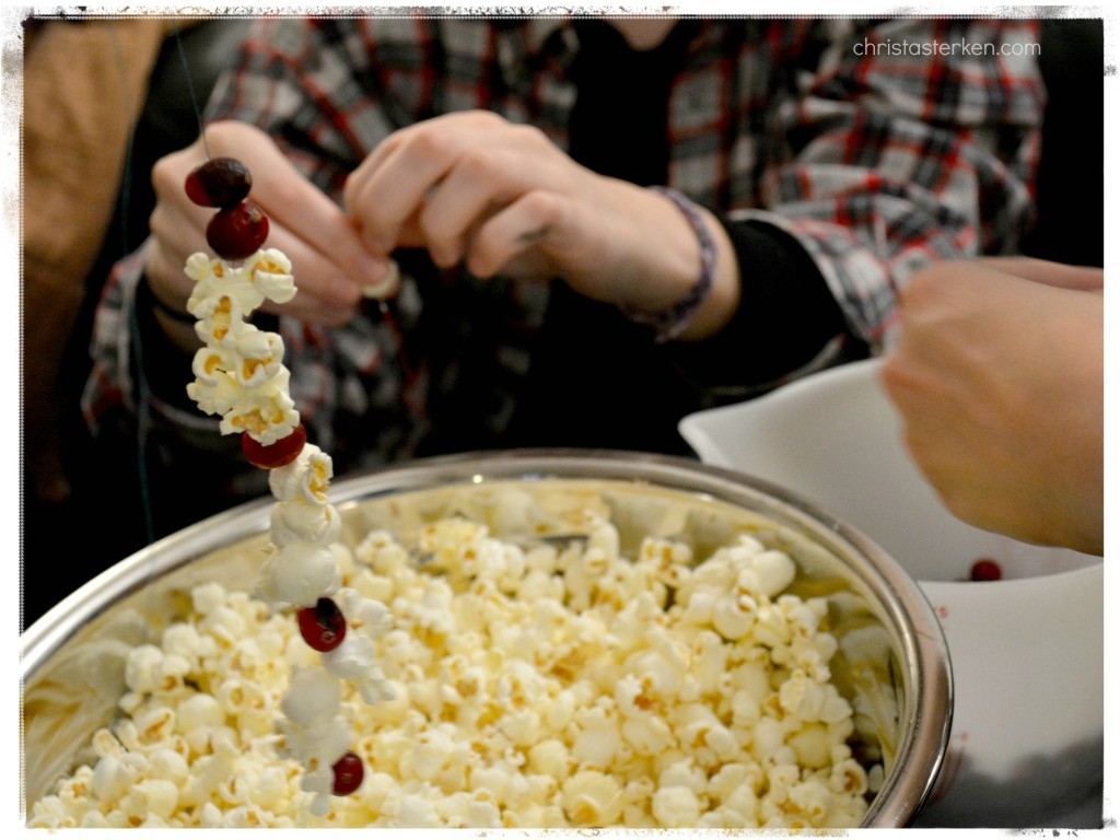 stringing popcorn and cranberries for a tree garland