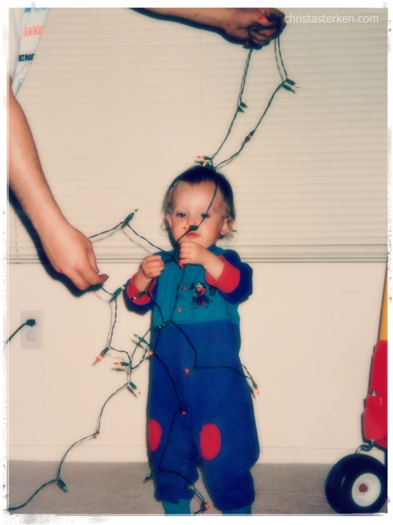 little girl detangling christmas lights