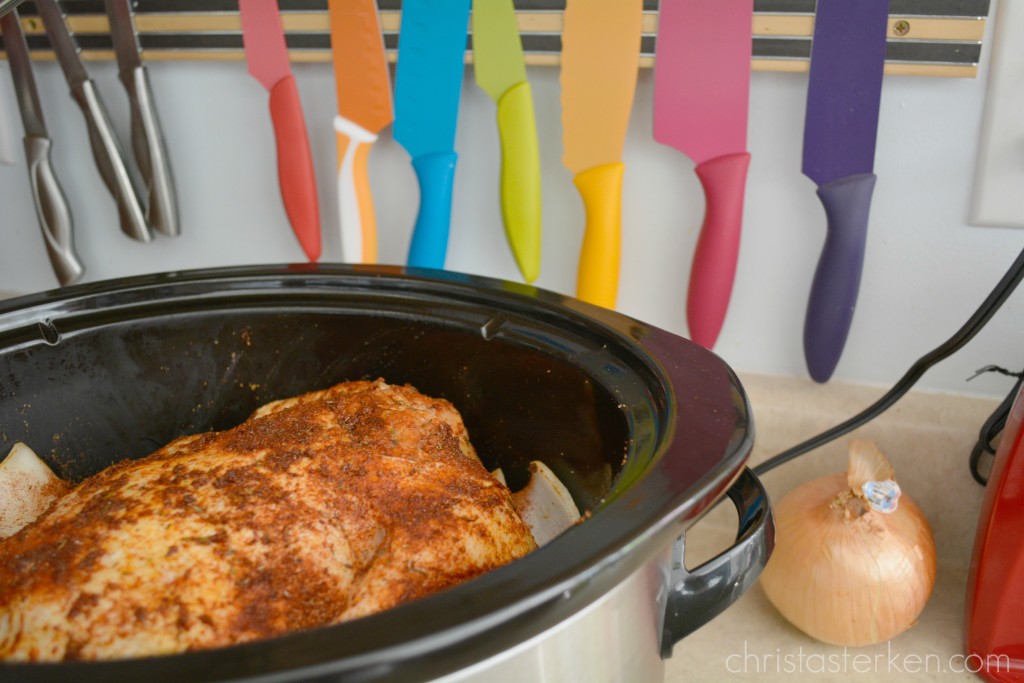 mom preparing a chicken for the crockpot