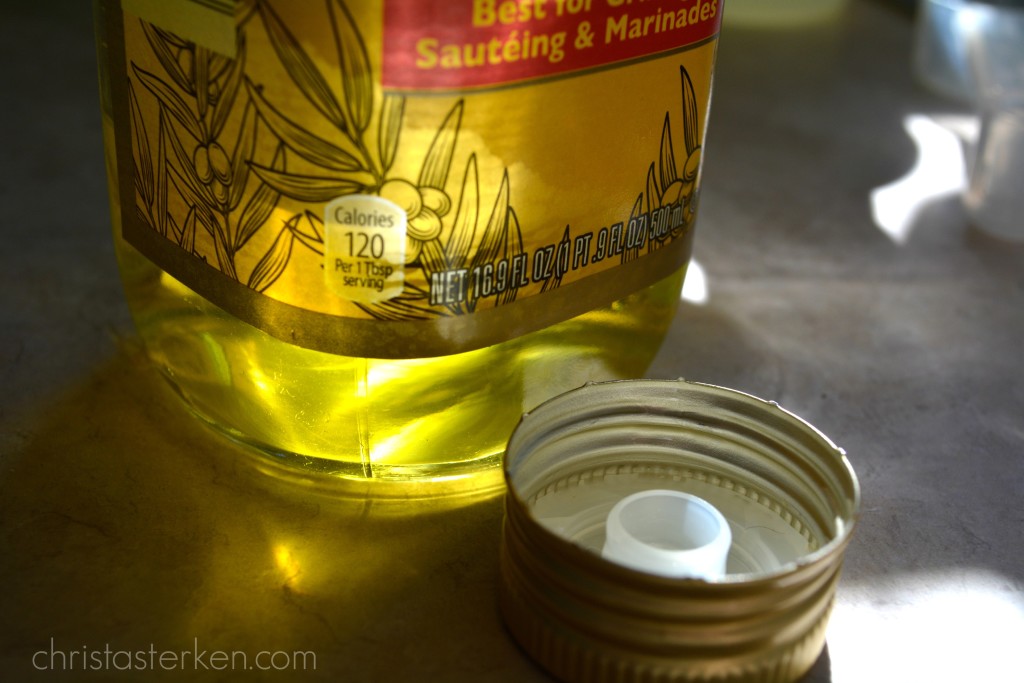 sun shining through olive oil bottle