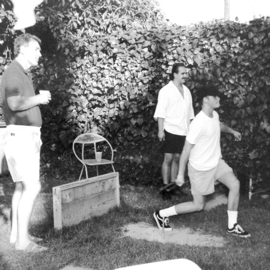 3 men drinking beer and playing horseshoes