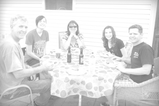 family eating dinner in the backyard