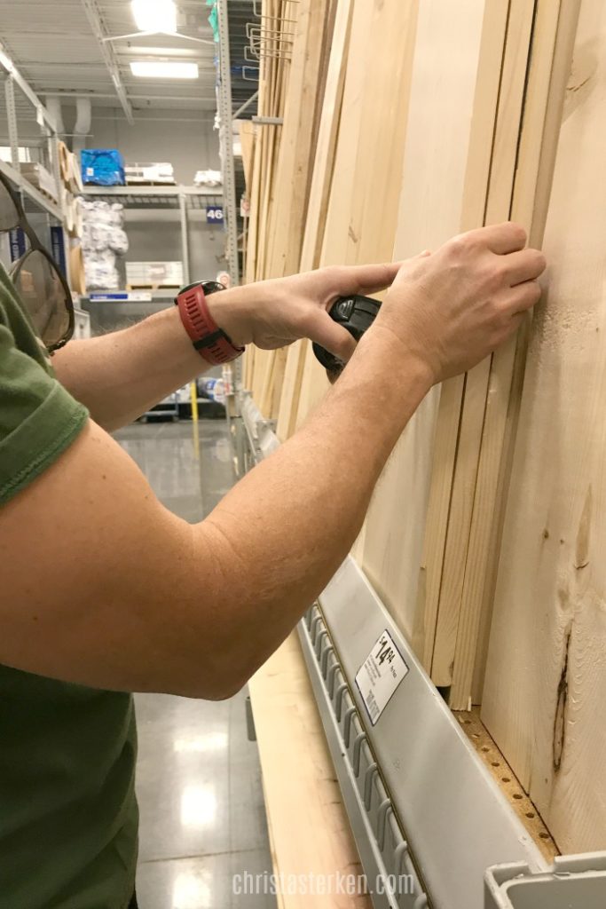 measuring wood in lumber store