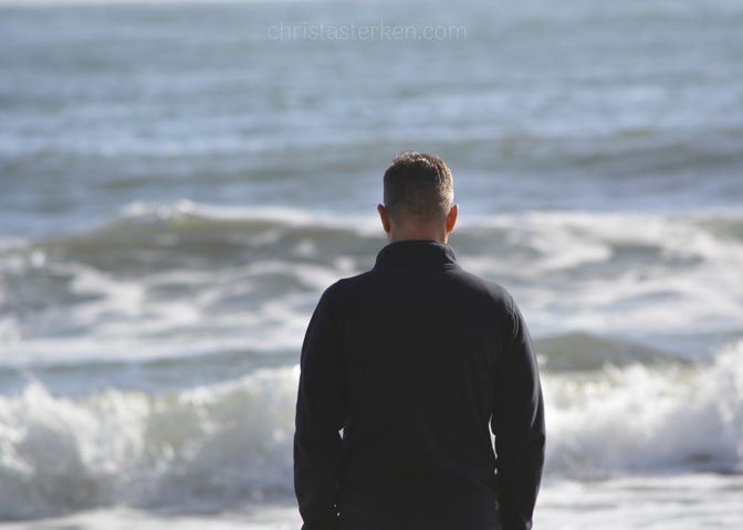 a man looking at ocean waves