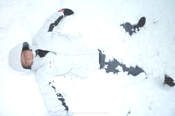 woman making snow angel