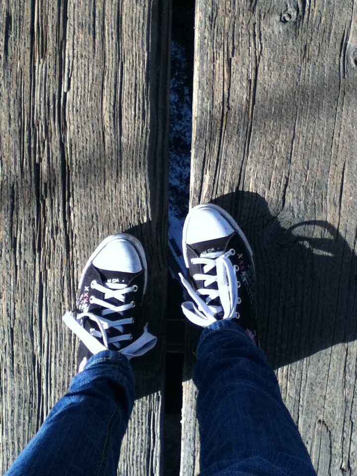 looking down at feel crossing a bridge