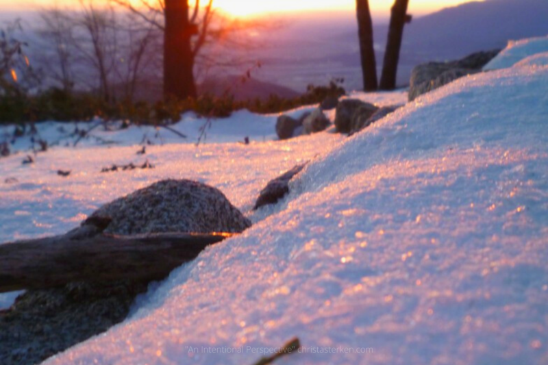 sun setting on snow