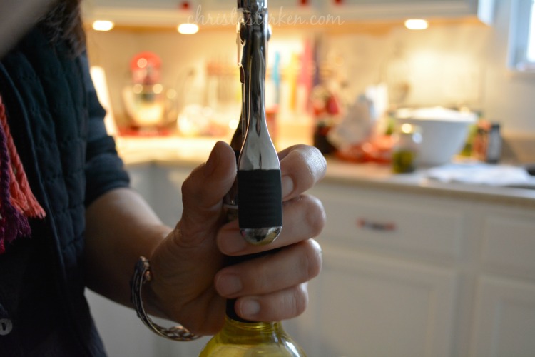 woman opening a wine bottle