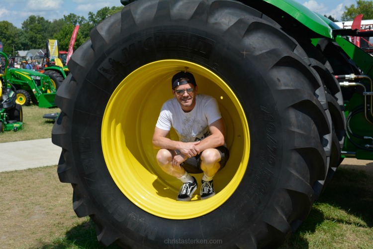 man in tractor wheel