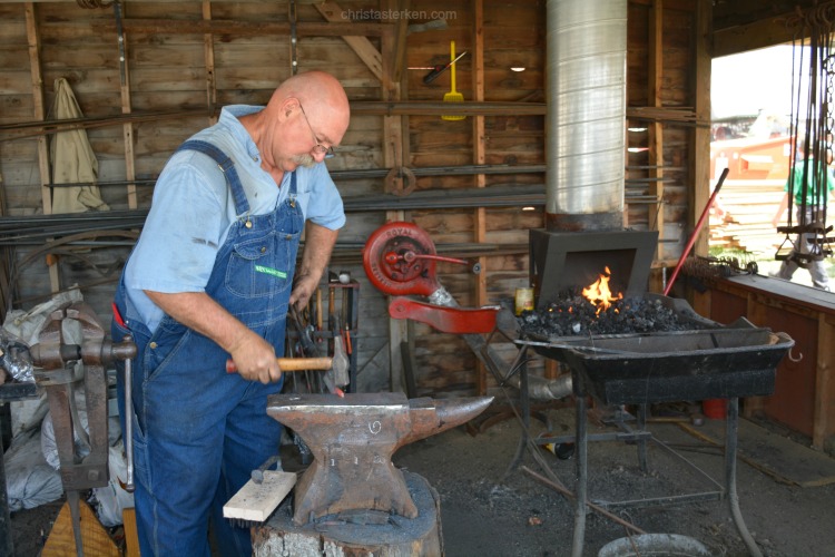 blacksmith hammering horseshoes