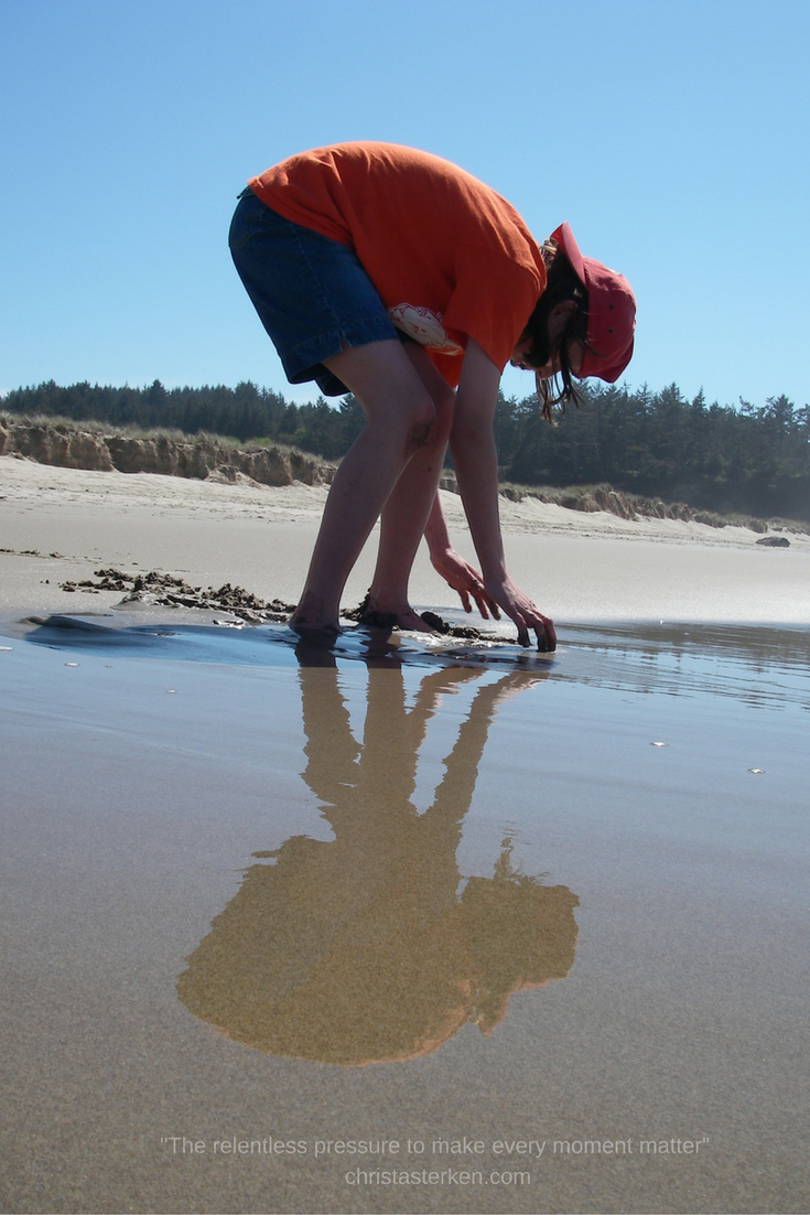 child playing in sand on beach