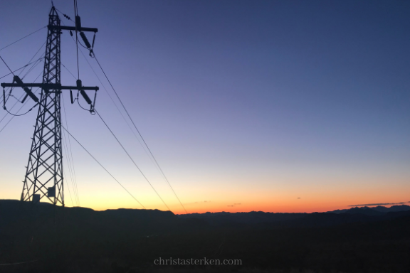 sunset behind electric tower