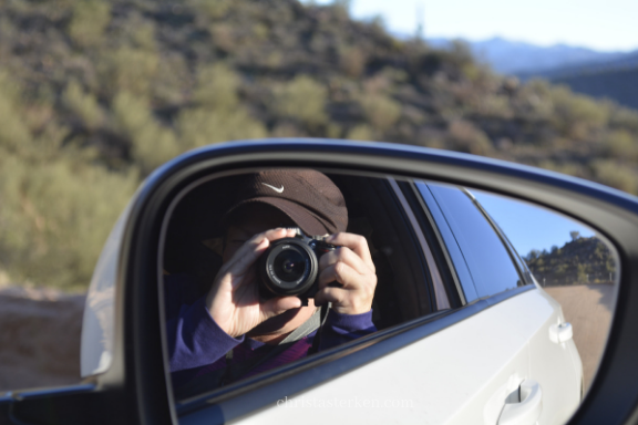 woman looking at camera in rearview mirror