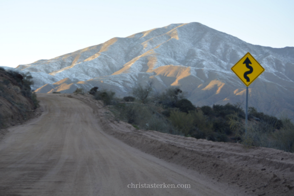 dirt road leading to snow mountains