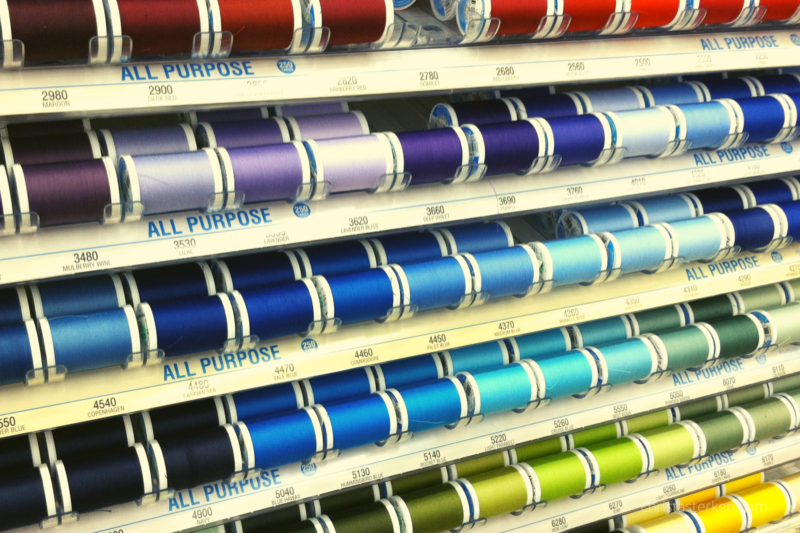 display of colored thread on store rack