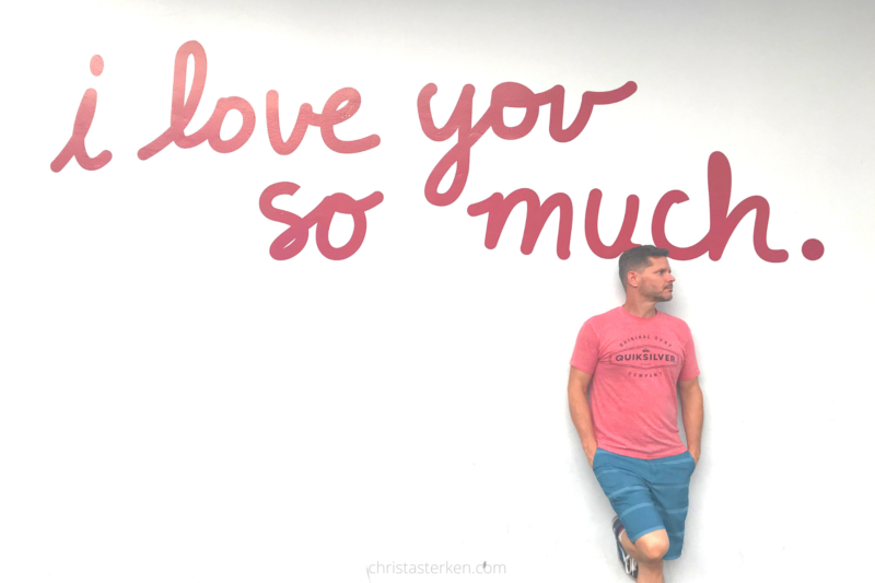 man by I love you so much mural sign