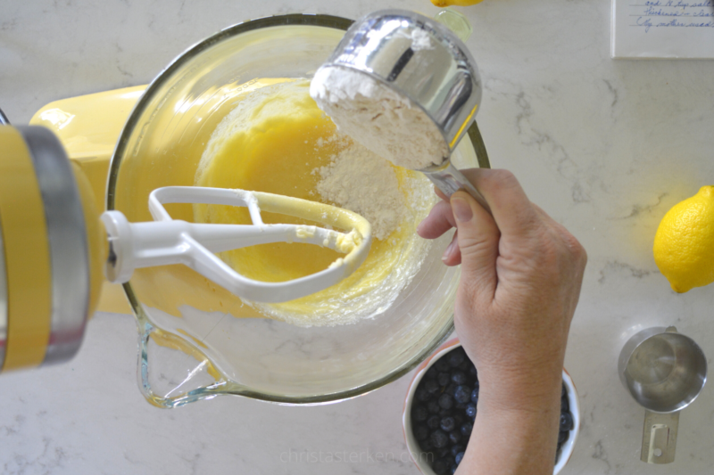 pouring flour into mixing bowl