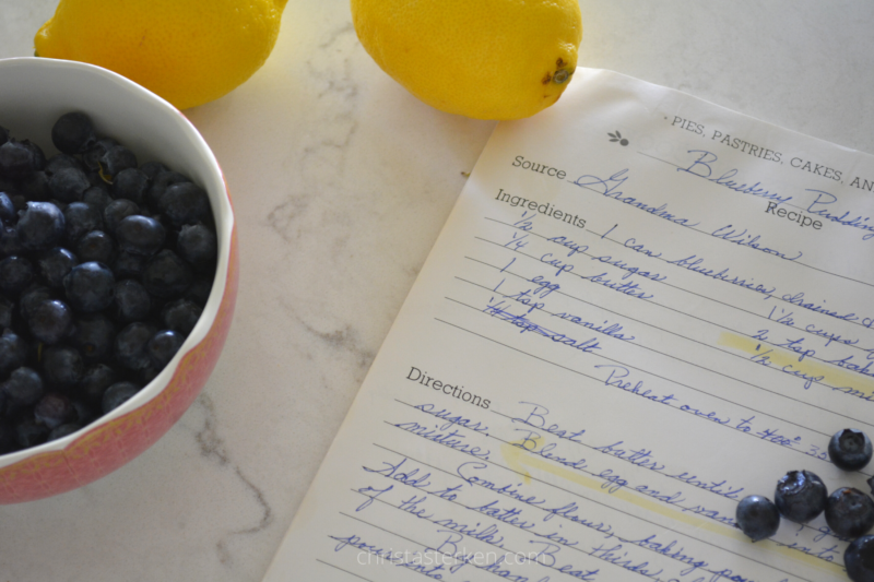 Grandma's recipe book with bowl of blueberries and lemons