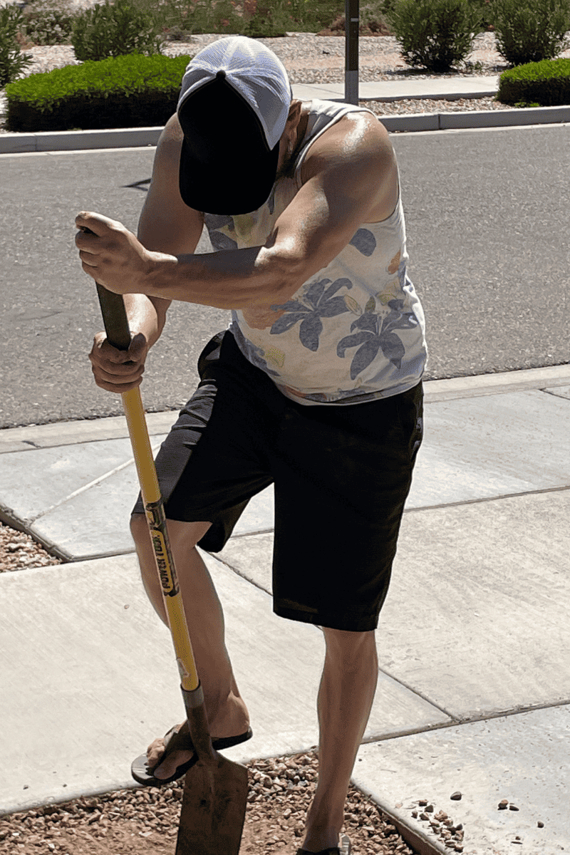 man digging hole for flagpole