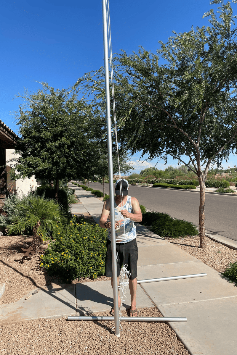 man digging hole for flagpole