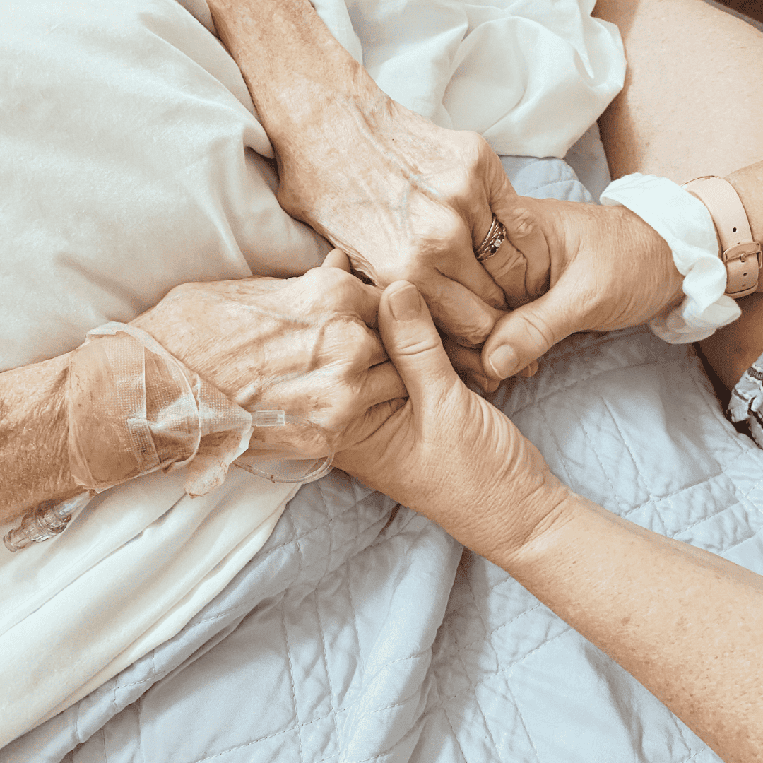 holding hands with aging loved one